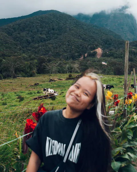 Deborah Chin, smiling, in a highland meadow